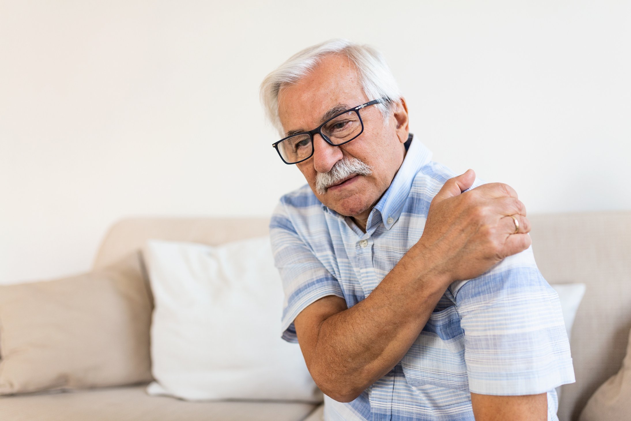 Old senior man with shoulder pain